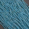 Close-up of blue beads on a dark background