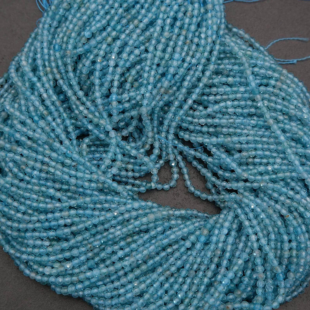 Close-up of a string of blue beads on a dark surface