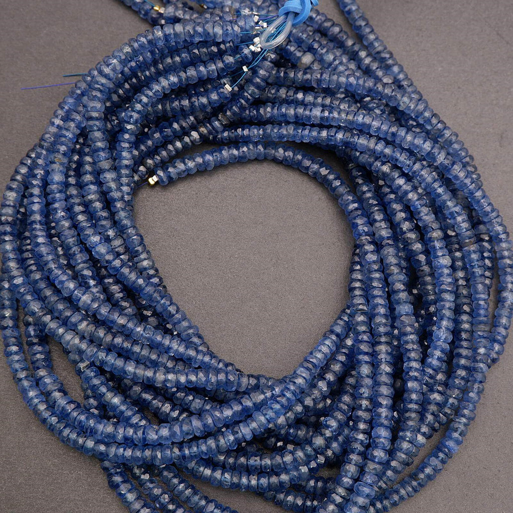 Coiled blue bead necklace on a gray background