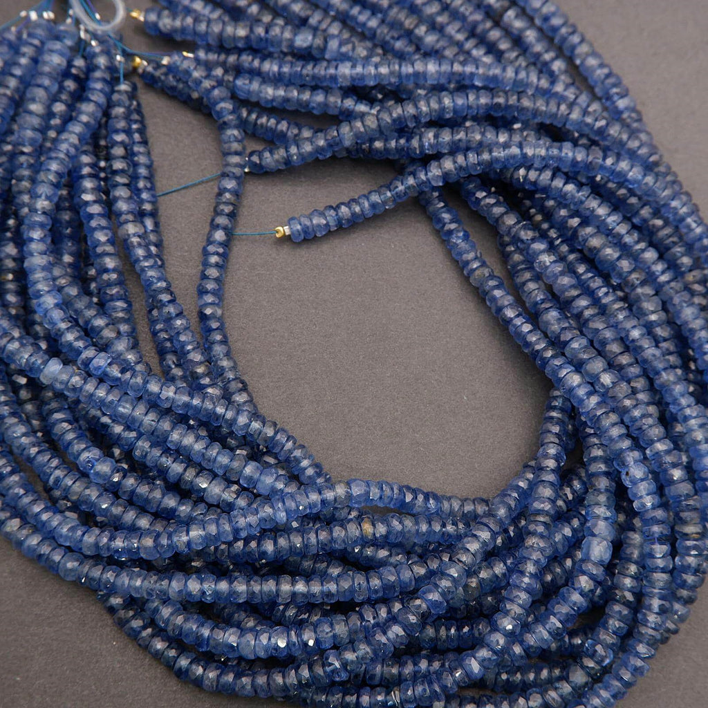 Coiled string of blue beads on a gray background