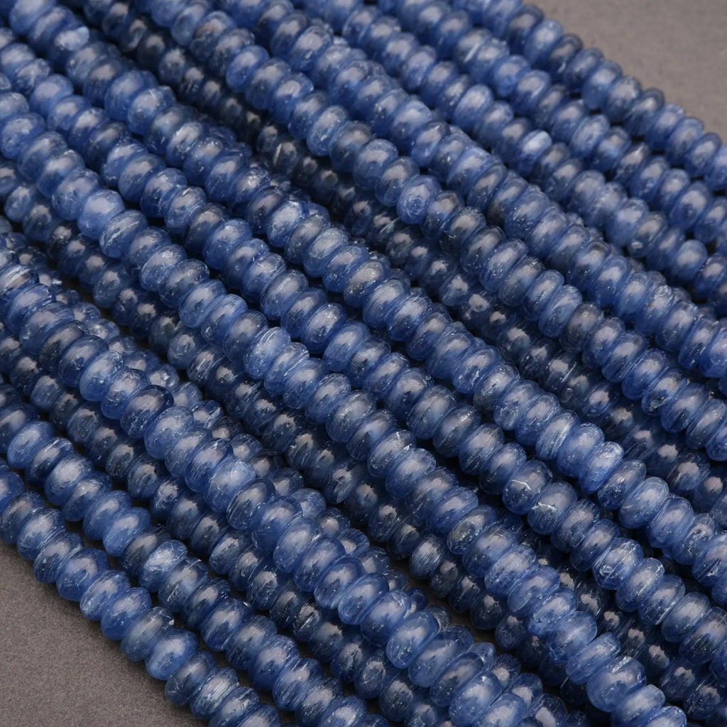 Close-up of blue kyanite beads on a gray background