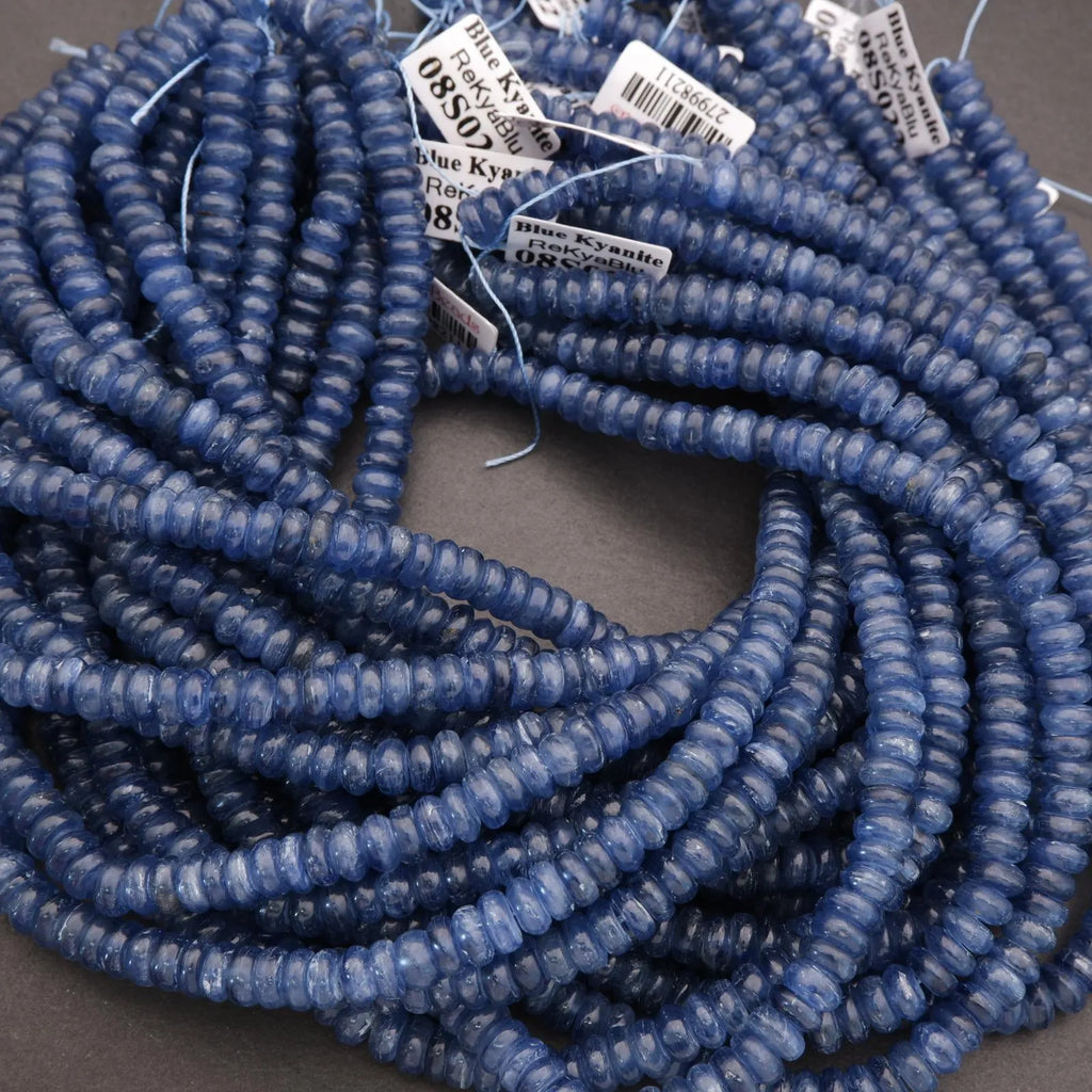 Coiled blue beads with labels on a dark background