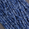Strands of blue kyanite rondelle beads showing chatoyant texture and sparkling faceted surfaces.