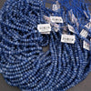 Blue kyanite gemstone beads with reflective facets and characteristic streaked texture.