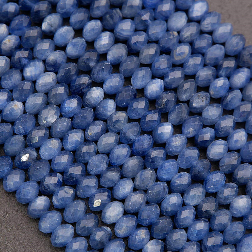 Close-up of blue faceted beads on a gray surface