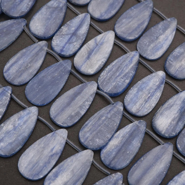 Close-up of blue teardrop-shaped tiles on a grid pattern