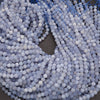 Close-up of blue and white beads on a string