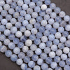 Close-up of blue and white marbled beads on a dark surface