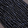 Close-up of dark blue beads on a gray background