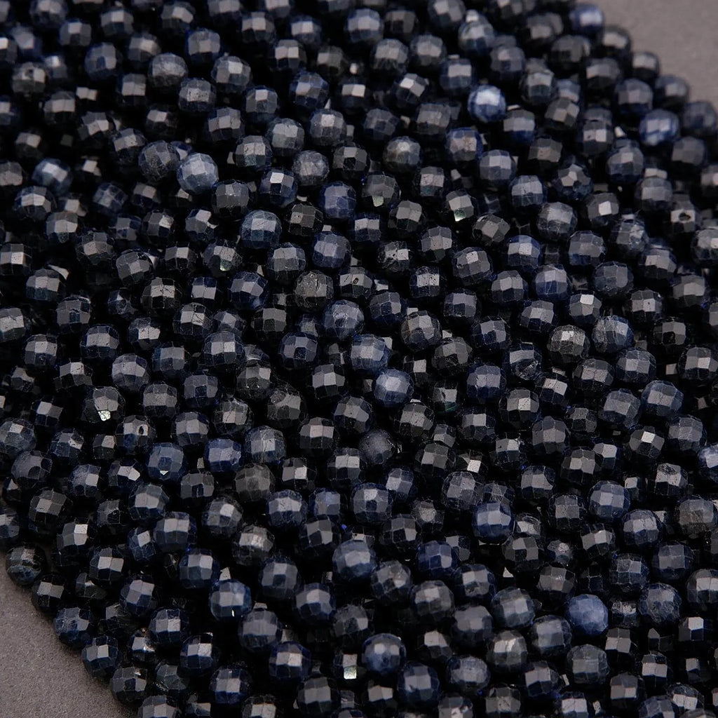 Close-up of dark blue beads on a gray background