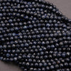 Close-up of dark blue faceted beads on a gray background