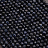 Close-up of dark blue beads arranged in a pattern