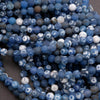 Close-up of blue and white marbled beads on a dark background
