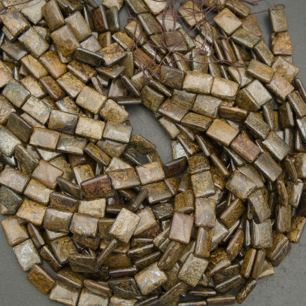 Close-up of a pile of small, square-shaped tiles in various brown tones.