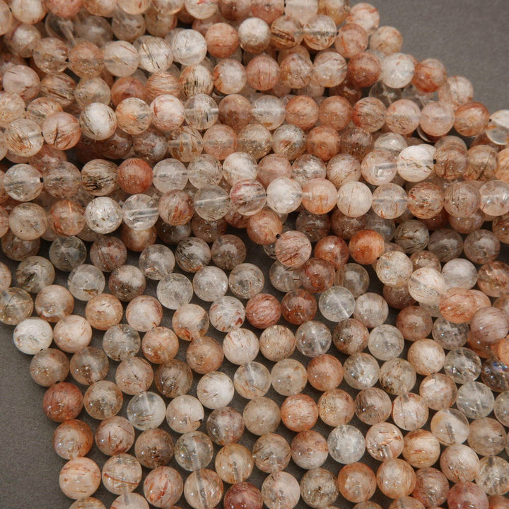Close-up of multicolored round beads on a gray background