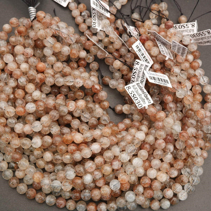 String of multicolored beads with price tags on a gray surface