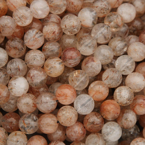 Close-up of marbled stone beads in various shades of brown and beige.