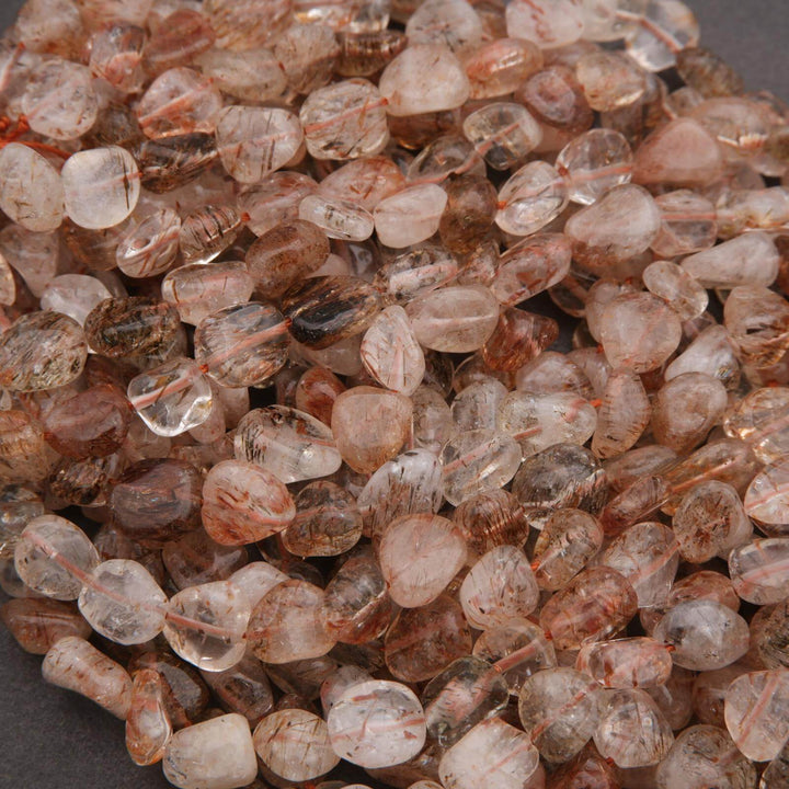 Close-up of small, translucent brownish-orange gemstones.