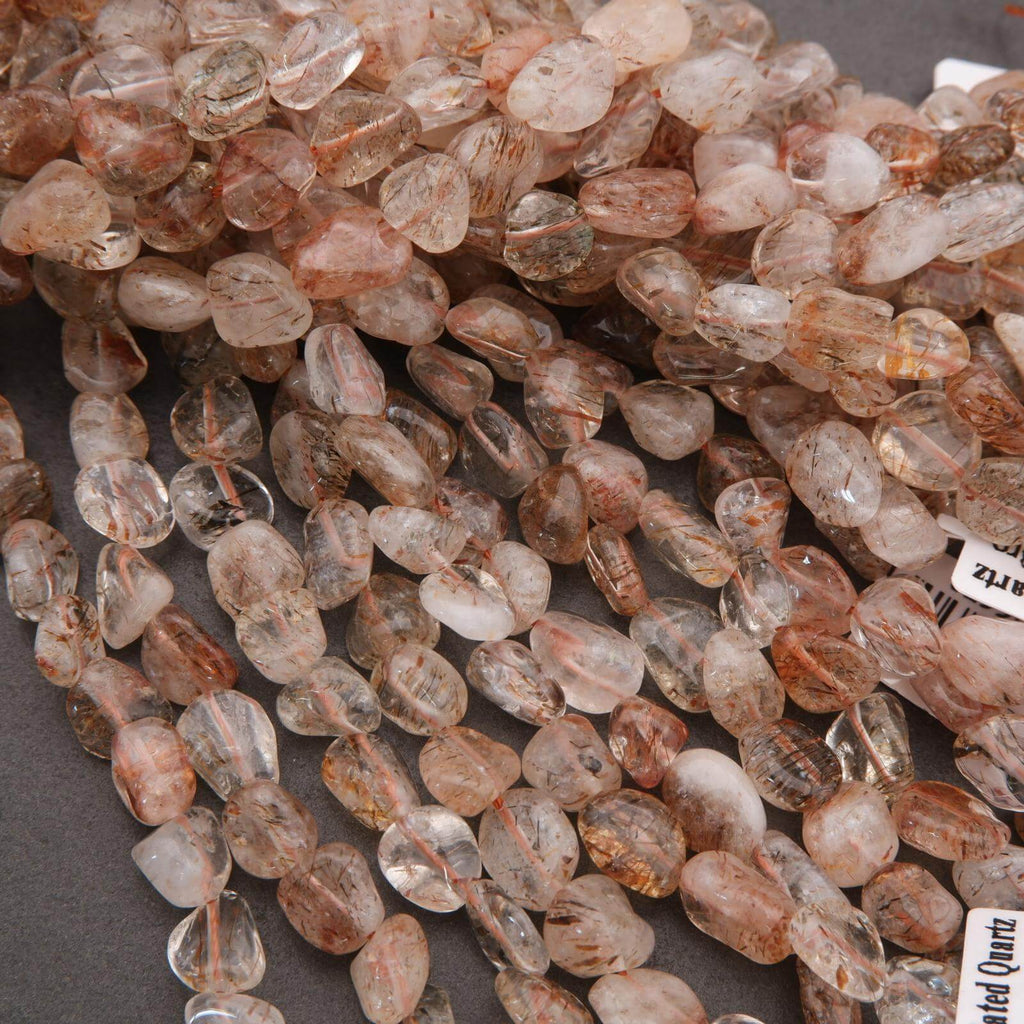 Close-up of a string of small, faceted gemstones on a gray background