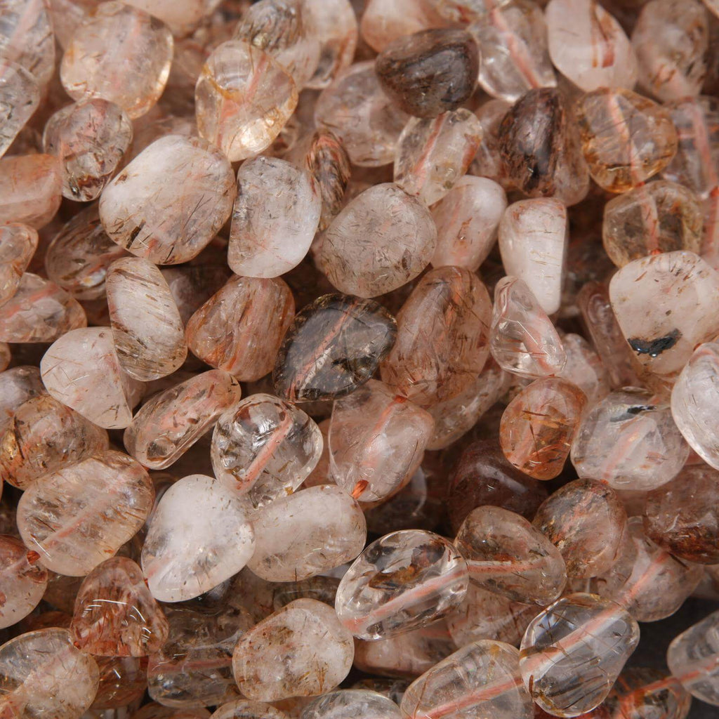 Close-up of a pile of small, transparent to translucent stones with brown and gray hues.