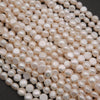 Close-up of a pile of white pearls on a dark background