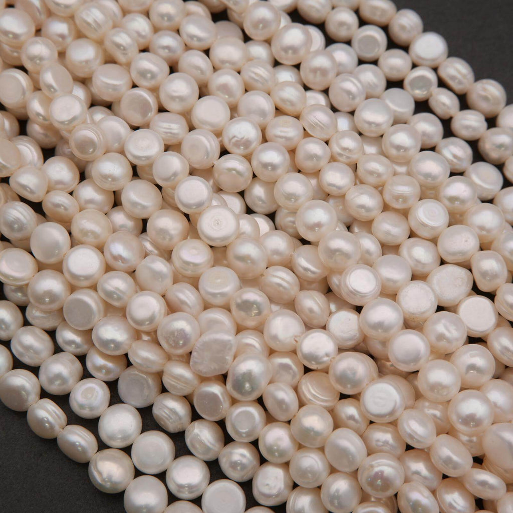 Close-up of a pile of white pearls on a dark background