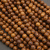 Close-up of a pile of brown peppercorns on a dark surface