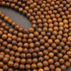 Close-up of a string of brown beads on a dark background