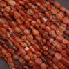 Close-up of red-orange beads on a dark background