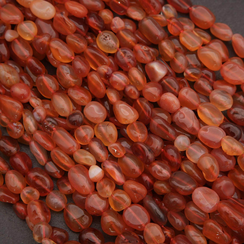 Close-up of red-orange beads on a dark background