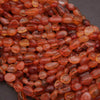 Close-up of red and orange beads on a dark background