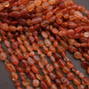 Close-up of red and orange beads on a dark background