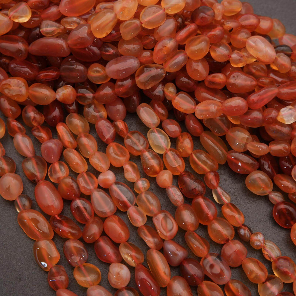 Close-up of red and orange beads on a dark background