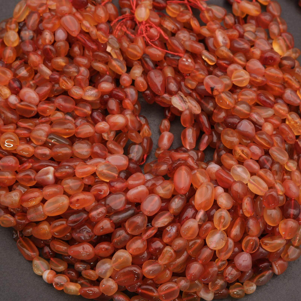 Close-up of a string of red-orange beads on a dark background