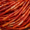 Close-up of orange and red stone beads.