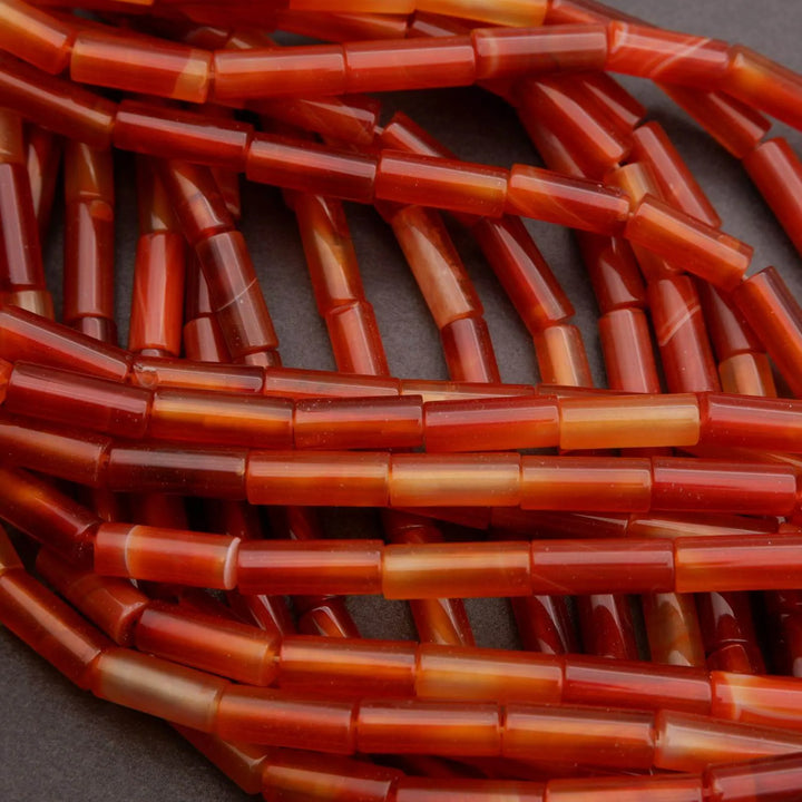 Close-up of red cylindrical beads on a dark background