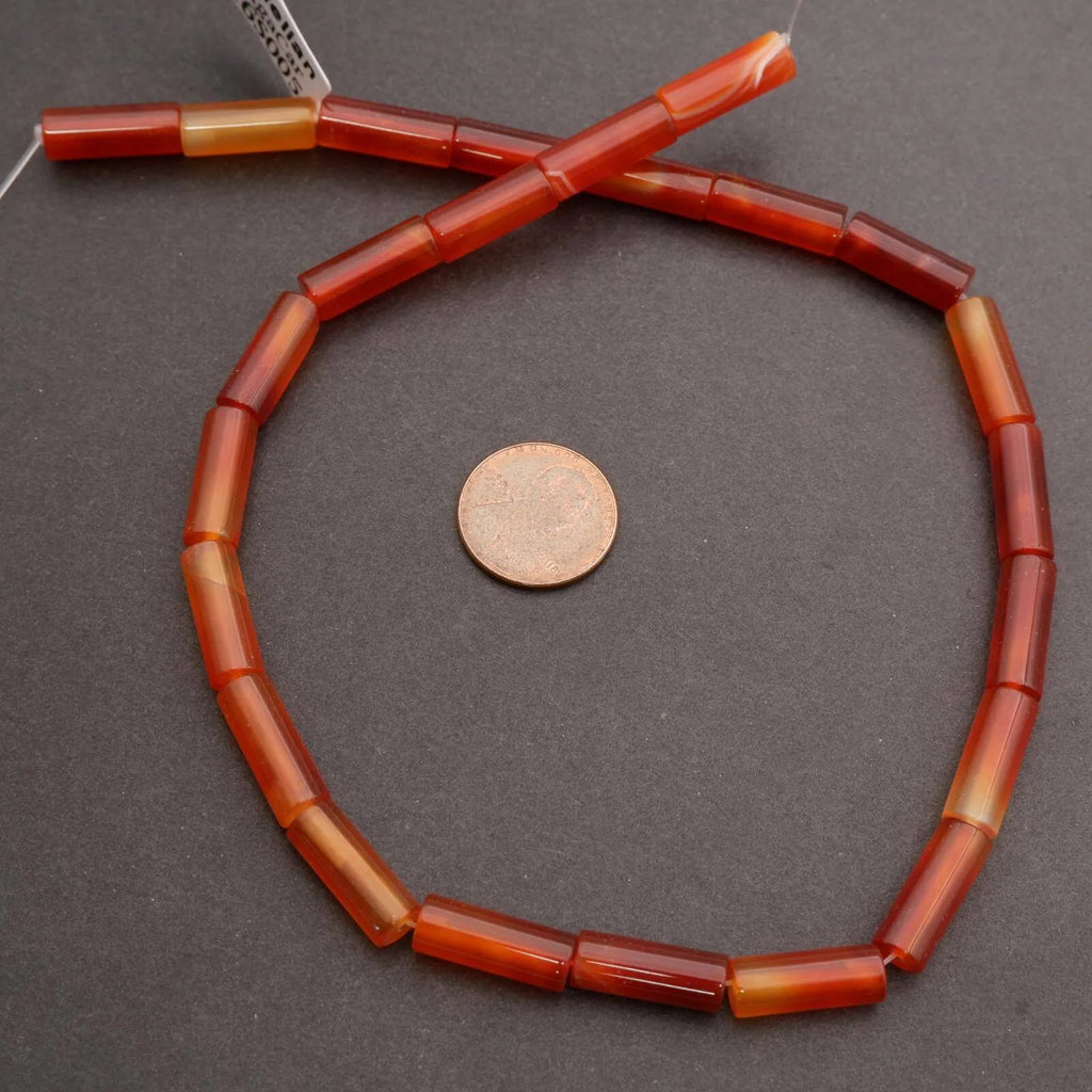 Necklace with red and orange beads on a gray background