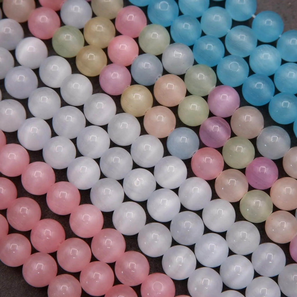 Close-up of pastel-colored round beads on a dark surface