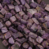 Close-up of purple stone chips on a dark surface