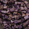 Close-up of purple and brown stone chips on a dark background