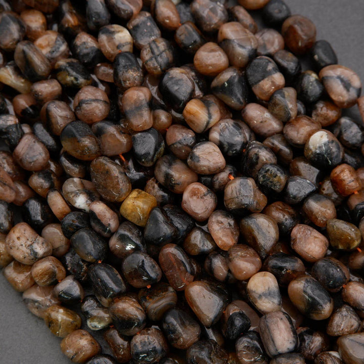 Close-up of small, multicolored pebbles on a gray background
