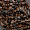 Close-up of small brown and black stones on a dark background