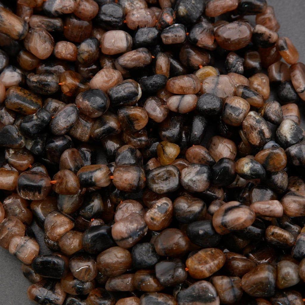 Close-up of small brown and black stones on a dark background