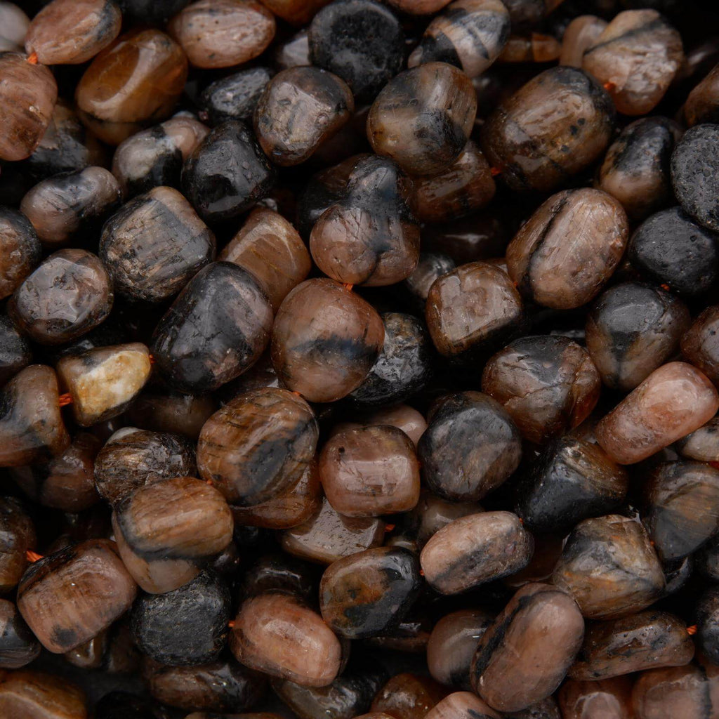 Close-up of small pebbles in various shades of brown and black.