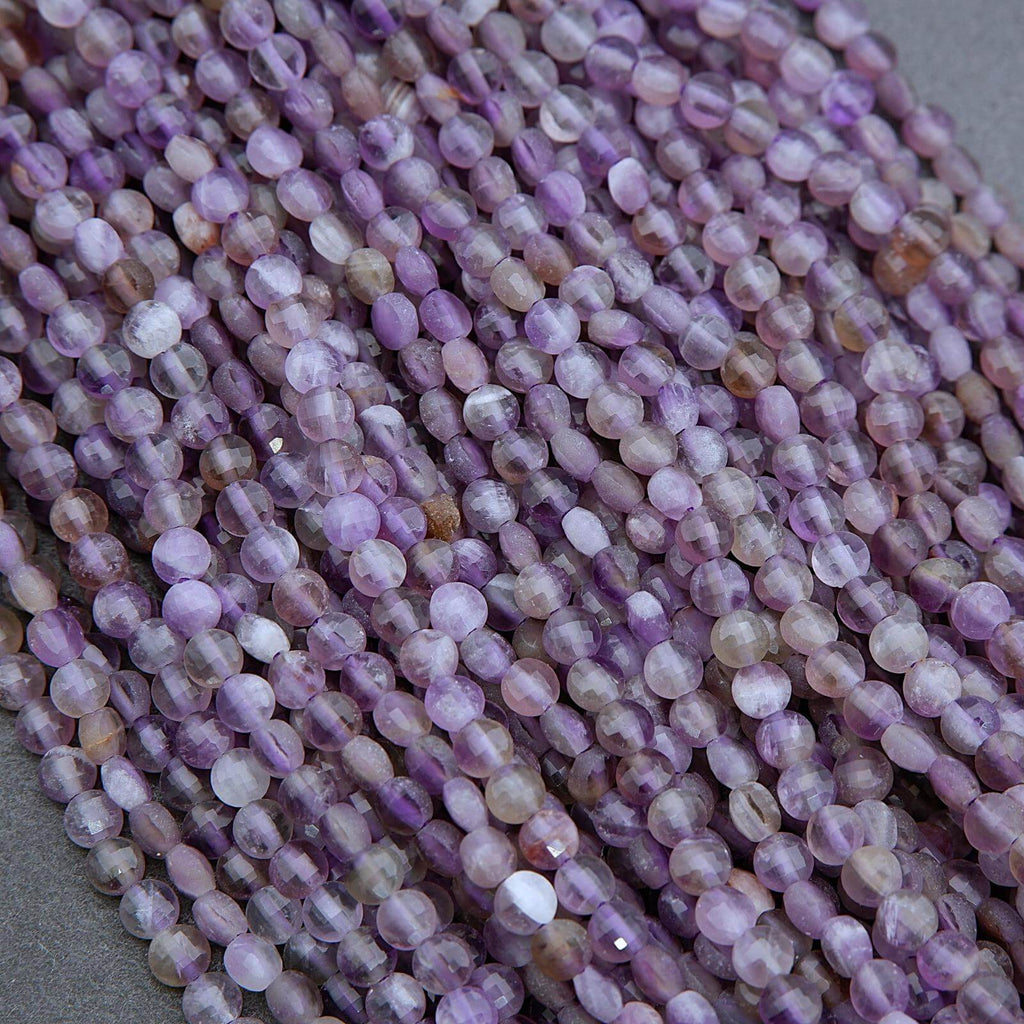 Close-up of a string of purple beads on a gray background