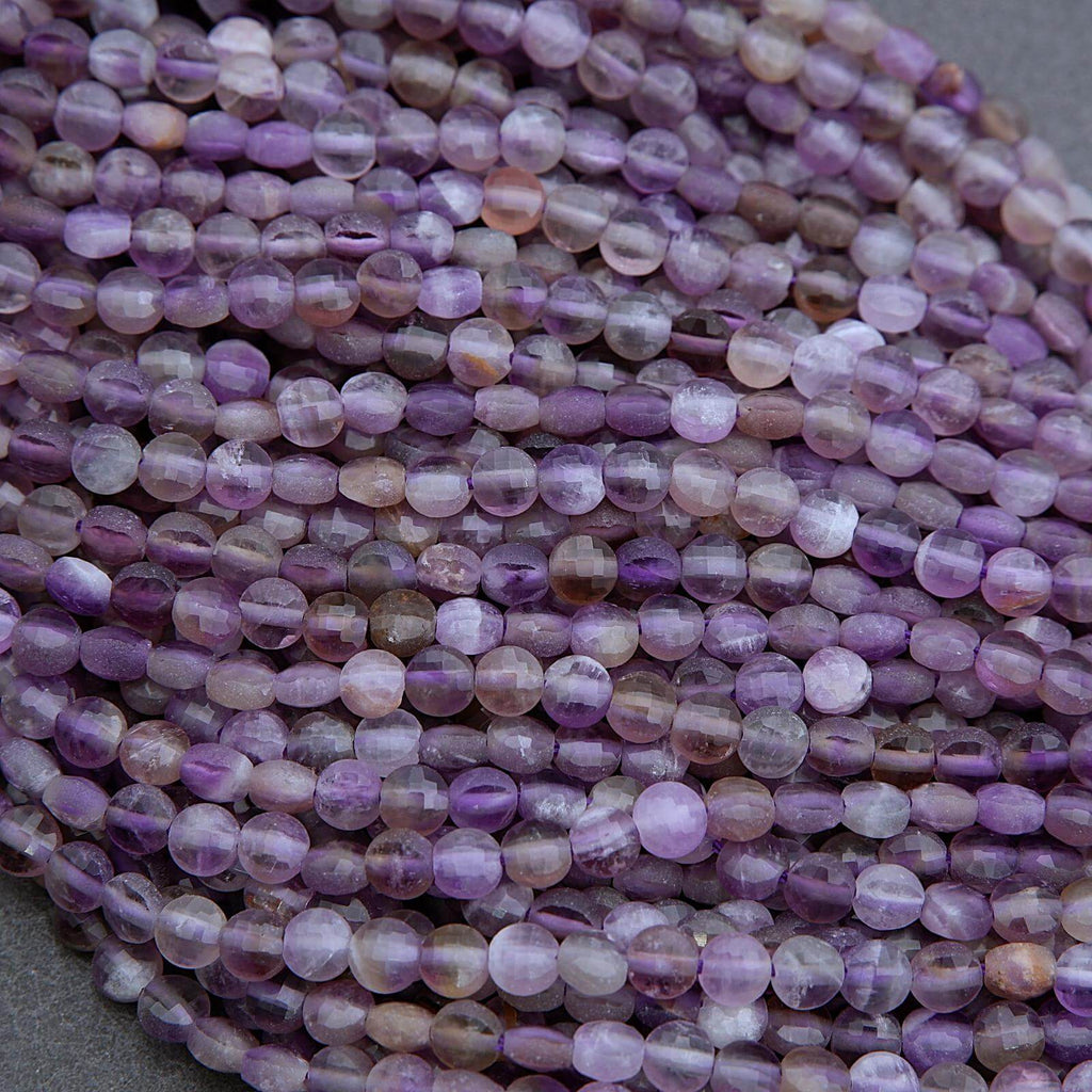Close-up of a string of purple beads on a gray background