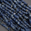 Close-up of blue stone beads on a gray background
