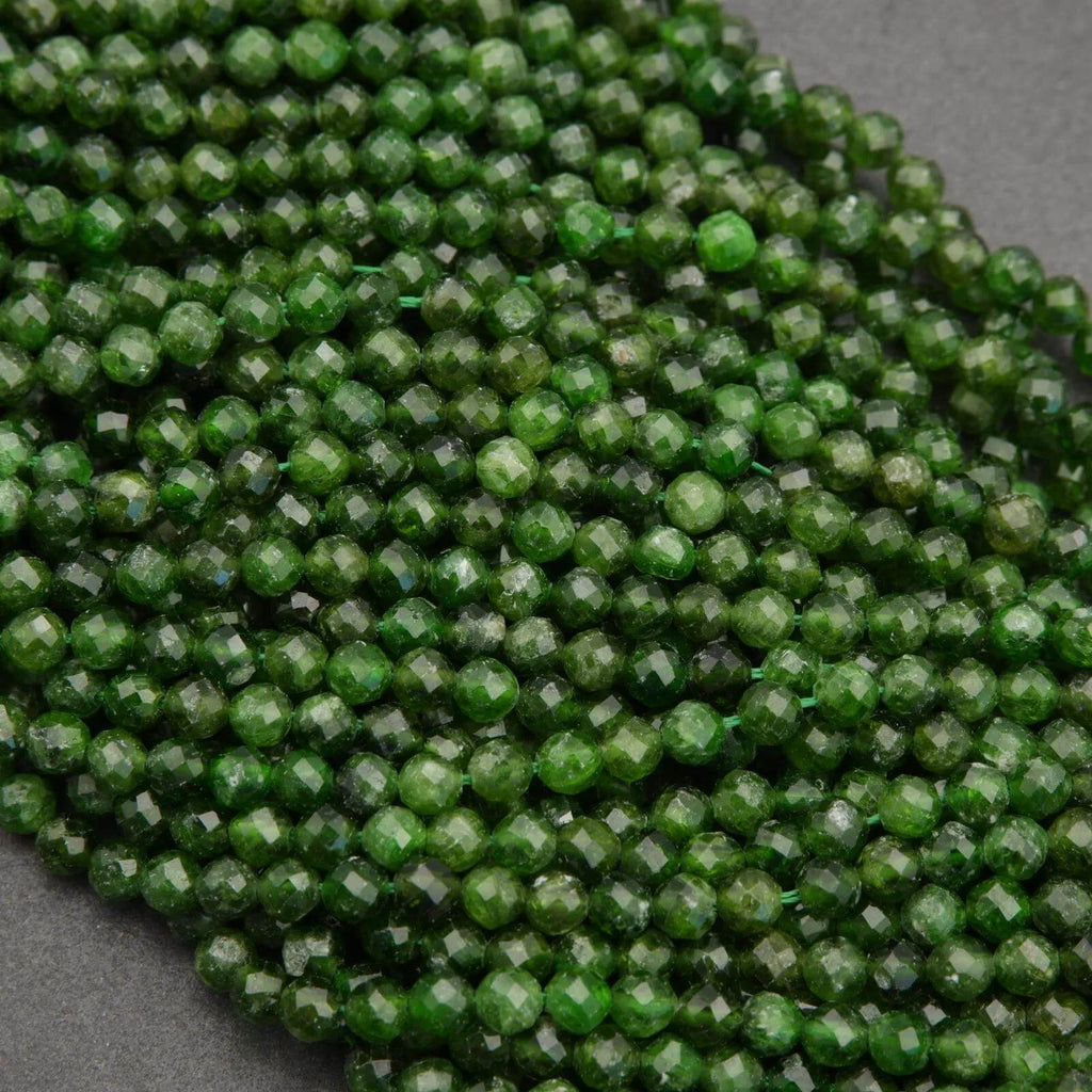 Close-up of green faceted beads on a gray background