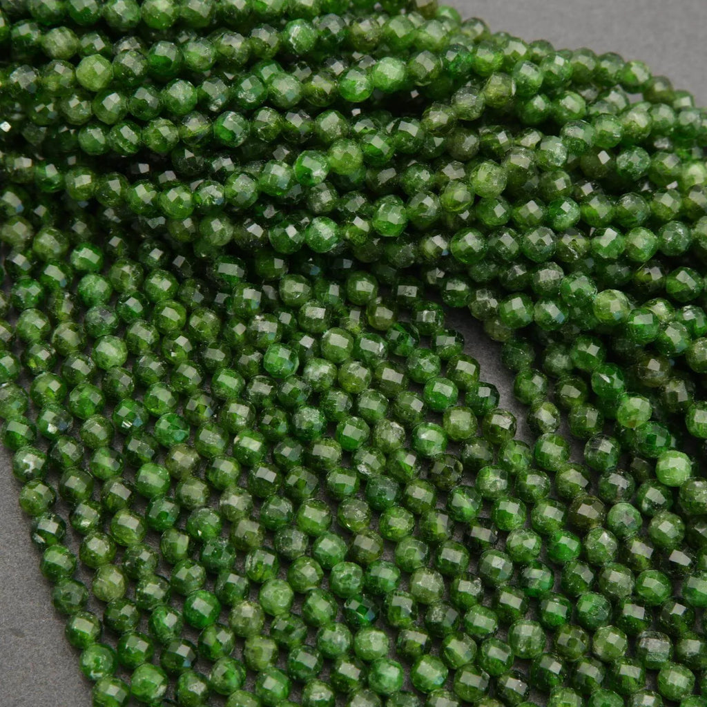 Close-up of green faceted beads on a gray background