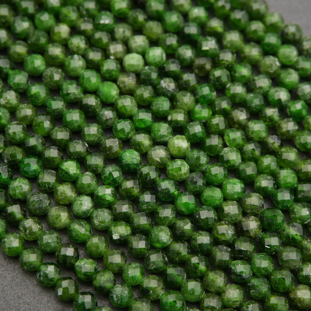 Close-up of green faceted beads on a gray background